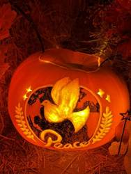 A carved pumpkin with a dove on it

AI-generated content may be incorrect.